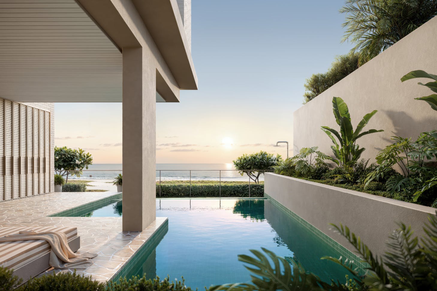 Luxury beachfront pool with tropical landscaping and ocean views at sunset, featuring modern architecture and serene outdoor design.